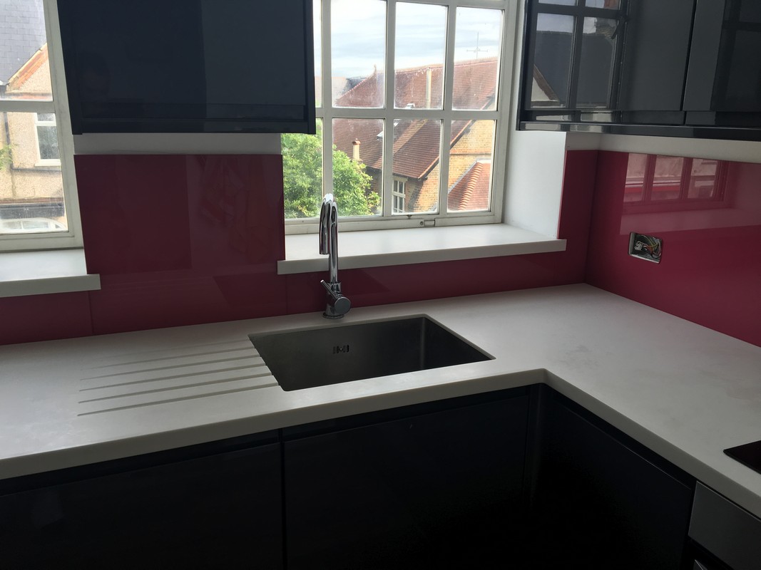 Deep plum coloured glass splashback in modern Windsor kitchen